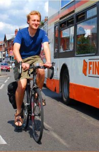 Cyclist alongside bus